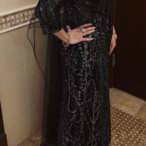 Elegant Exquisite shimmering black gown with tulle overlay.